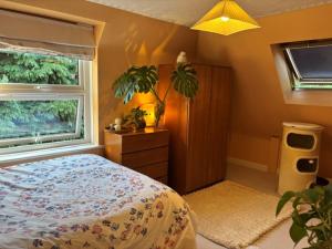 a bedroom with a bed and a window at The private Minton Mews No 3 in Bournemouth