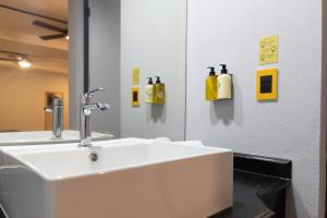 a bathroom with a white sink and a mirror at Hotel Escala Centro Histórico in Mexico City +12 photos