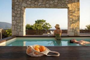a woman in a swimming pool with a basket of fruit at Accessible Villa Katoi in Angón