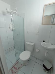 a white bathroom with a toilet and a sink at Pousada Maceió é Massa Beira Mar in Maceió +83 photos