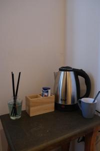 a coffee maker and a tea kettle on a table at URBAN House Vienna in Gerasdorf bei Wien +38 photos