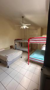 a room with three bunk beds and a ceiling at Hostal Sam in Managua