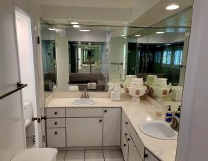 a bathroom with two sinks and a large mirror at Luxury Spa Townhome with Rooftop Ocean View Jacuzzi in Hermosa Beach +29 photos