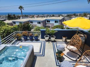 a hot tub on a balcony with a view of the ocean at Luxury Spa Townhome with Rooftop Ocean View Jacuzzi in Hermosa Beach
