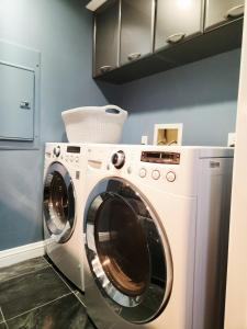 a washer and dryer in a laundry room at Luxury Spa Townhome with Rooftop Ocean View Jacuzzi in Hermosa Beach