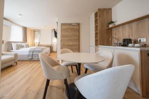 a kitchen and a living room with a table and chairs at Casa Plus in Villach