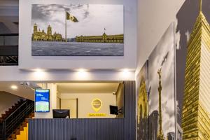 a picture of a building with a flag on the wall at Hotel Escala Centro Histórico in Mexico City