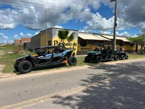 two atvs parked on the side of a street at Inn R1 Pousada e Passeios in Barreirinhas
