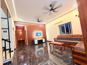 a living room with a couch and a table at Vihaalaya stays in Tozhuppedu