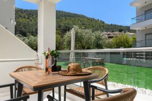 a patio with a table and chairs on a balcony at Aeliana Thassos Studios & Lofts in Skala Rachoniou