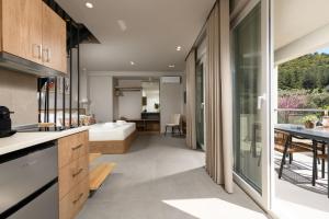 a kitchen and living room with a view of a bedroom at Aeliana Thassos Studios & Lofts in Skala Rachoniou
