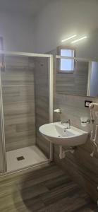 a bathroom with a white sink and a shower at Hotel Sole in Eraclea Mare +35 photos