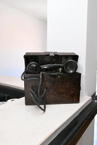 an old suitcase with a pair of scissors in it at Hostel Holiday Cetinje in Cetinje
