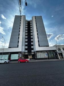 a red car parked in front of a building at The Safari Launchpad Windhoek in Windhoek