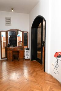 a living room with a desk and a mirror at Hostel Holiday Cetinje in Cetinje