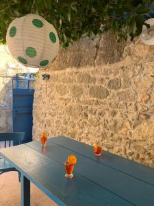 a blue table with oranges in front of a stone wall at Dalmatian rustic house in Petrcane