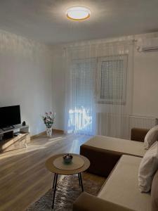 a living room with a couch and a table at Verde Apartment in Banja Luka