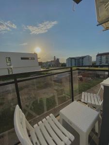 two chairs and a table on a balcony with a view at Verde Apartment in Banja Luka