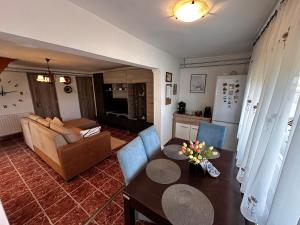 a living room with a couch and a table at Éva Vendégház in Hajdúnánás
