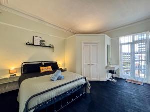 a bedroom with a bed and a large window at Longsands Beach, Apartment 2, Tynemouth in Tynemouth
