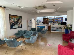 a waiting room with couches and chairs at Hotel Corallo in Torre Santa Sabina