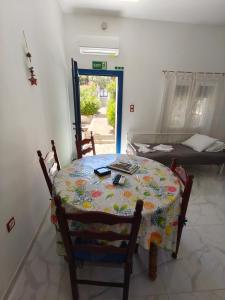 a table and chairs in a room with a bed at white and blue,finikas syros in Víssa