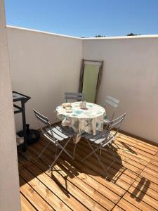 a table and chairs in a room with a mirror at Maisonnette Oléron à 30 mètres de la plage 3 étoiles in Saint-Denis-dʼOléron +22 photos