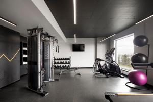 a gym with exercise equipment in a room at Alt Hotel Ottawa Airport in Ottawa