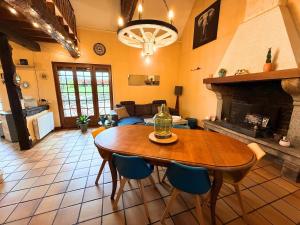 a living room with a table and a fireplace at Maison paisible Normandie in Saint-Aubin-de-Terregatte +15 photos