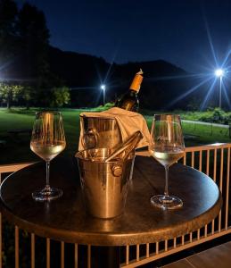 a table with a bottle of wine and two glasses at Stan na dan Bumbar in Kostajnica