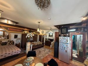 a living room with a couch and a refrigerator at Villa Éden in Siófok