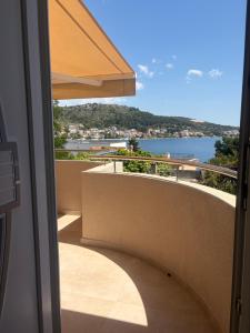 a balcony with an umbrella and a view of the water at Apartmani Maleš in Rogoznica