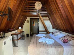 a bedroom with a large bed with wooden ceilings at Complexo Turístico Canaã in Nobres +42 photos