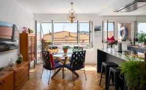 a kitchen with a table and chairs in a room at Ático La Mallera in Luanco