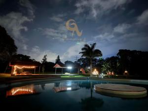 a swimming pool at night with a sign that says chaya at Domo Nool con vista a las estrellas in Río Blanco