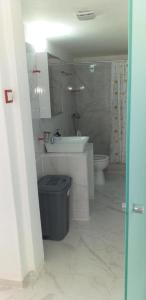 a bathroom with a sink and a toilet at white and blue,finikas syros in Víssa +25 photos