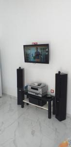 a living room with a tv on a wall at white and blue,finikas syros in Víssa