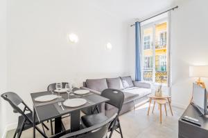 a living room with a table and chairs and a couch at Meilleur emplacement de Nice Charming Flat #3 in La Celle-sous-Gouzon