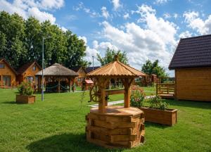 a wooden playground with a wheel in a yard at Domki Nad Morzem Sobiescy in Stegna