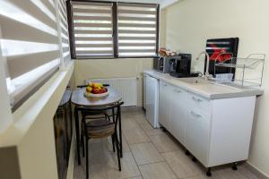 a kitchen with a table with a bowl of fruit on it at Casa SEMA in Sinaia