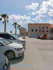 a row of parked cars in a parking lot at Apartman Mare in Kaštela