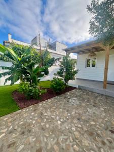 a home with a walkway in front of a house at Casa Ana & Spa in Conil de la Frontera