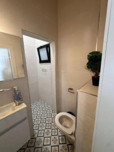 a bathroom with a toilet and a sink at קסם צפתי in Safed +10 photos