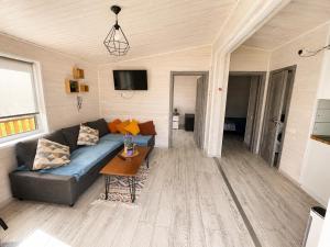 a living room with a couch and a table at Jaunas Ilgas in Medumi