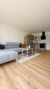 a living room with a couch and a table at Nord Loft in Langeoog +17 photos