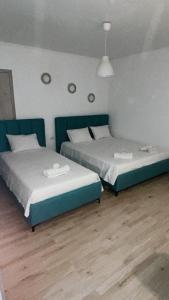 two beds in a room with two beds sidx sidx sidx sidx at Kostaki spila apartment in Himare