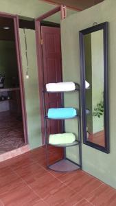 a chair sitting in a room next to a mirror at Green house in Puerto Jiménez