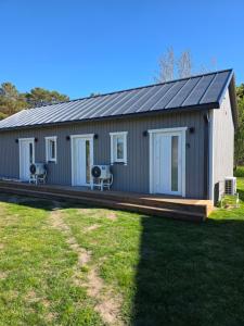 a house with a solar roof on a yard at APARTAMENTI BrivdienuKolka in Kolka