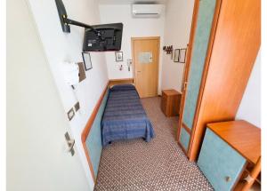 a hospital room with a bed in a room at Hotel Conti in Rimini