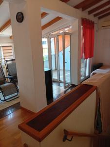 a bedroom with a bed and a view of a living room at Studio Mare in Kaštela